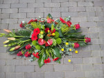 rouwbloemstuk in herfsttinten gegroepeerd